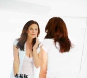 Portrait of a mature woman stroking her beautiful face